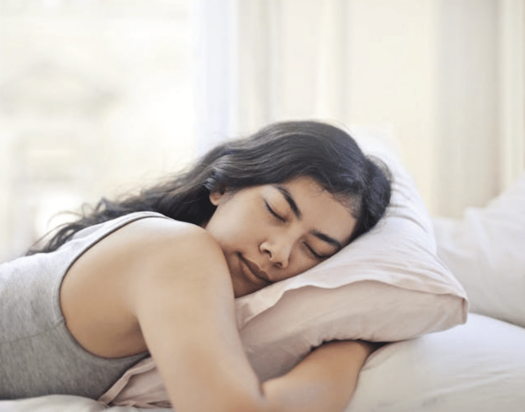 https://www.pexels.com/photo/woman-in-gray-tank-top-lying-on-bed-3807760/